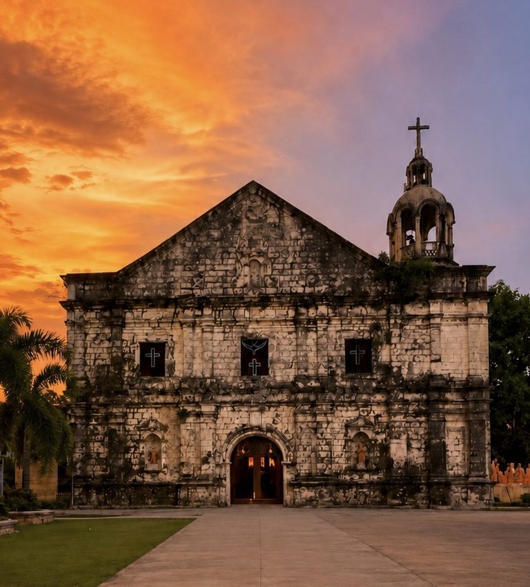 Stone facade of San Andres Church in Masinloc, Zambales, at sunset